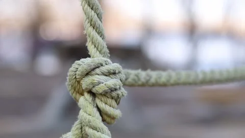 Close-up of thick light-colored ropes tied into a knot Video stock 331502228