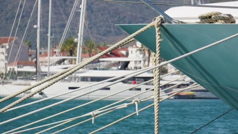 Close-up of thick mooring ropes on a pier with yachts Stock Footage 313731101