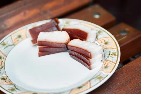 Close-up of thick sliced cured bacon and smoked pork lard on a ceramic plate Stock Photos
