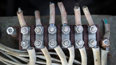 Close-up of thick, worn electrical cables with yellowed insulation, securel.. Stock Photos