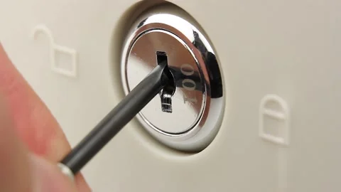 Close-up thief screwdriver trying to open lock, attempt rob safe or cash drawer Stockbeeldmateriaal 145535912