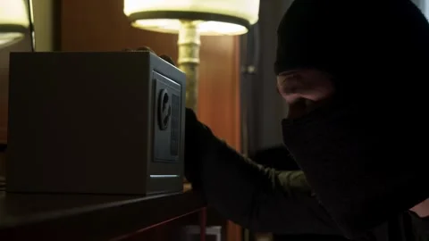 Close up of thief using power drill to crack safe, then grabbing bundles of cash Stock Footage 323535215