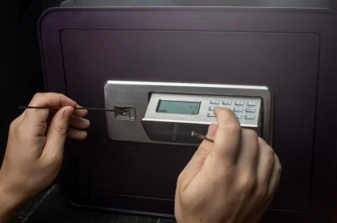 Close-up of Thief's hands attempting to Break Home Money Safe and perform Rob Stock Photos