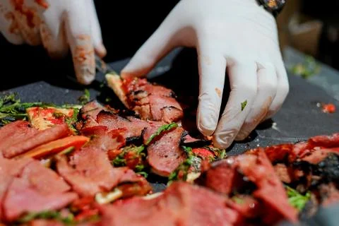 Close up Thin bread with pastrami a tomato and greens. Stock Photos