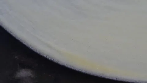 Close Up of Thin Crepe Batter Spreading on Hot Griddle Stock-Footage 345651378