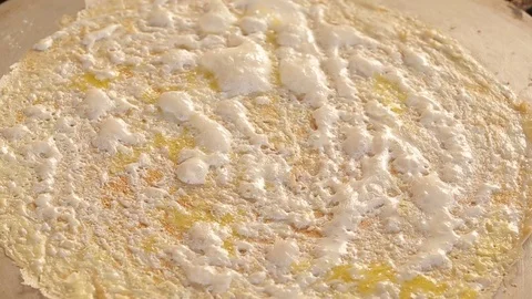 Close-up of a thin dough cake that is fried on a tandoor. Video stock 118236298