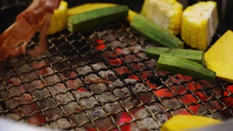 Close-up of thin meat slice held by tongs over a charcoal grill. Assorted v.. Stock Footage 334265339