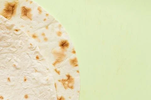 Close-up of thin pita bread texture on green cutting board related to bread.. Stock Photos