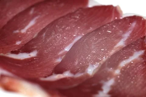 Close-up of thin slices of raw cured duck breast meat arranged closely togeth 스톡 사진