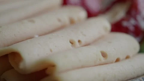 Close-up of Thinly Sliced Deli Meat on a Plate Stock Footage 345389254