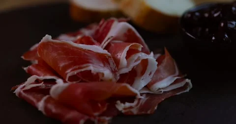 Close-up of thinly sliced jamon showing rich marbling and delicate texture of Stock Footage 309507708