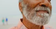 Close-Up Of Thoughtful Active Senior African American Man Standing On The Beach Stock Footage