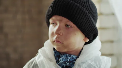 Close Up of Thoughtful Boy in Black Hat and Protective White Jacket Stock Footage 317984210
