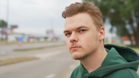 Close up of A thoughtful man who is staring away from camera near the traffic Stock Footage 91230963