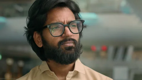 Close up thoughtful pensive 30s Arabian bearded businessman in glasses looking Stock Footage 250453113