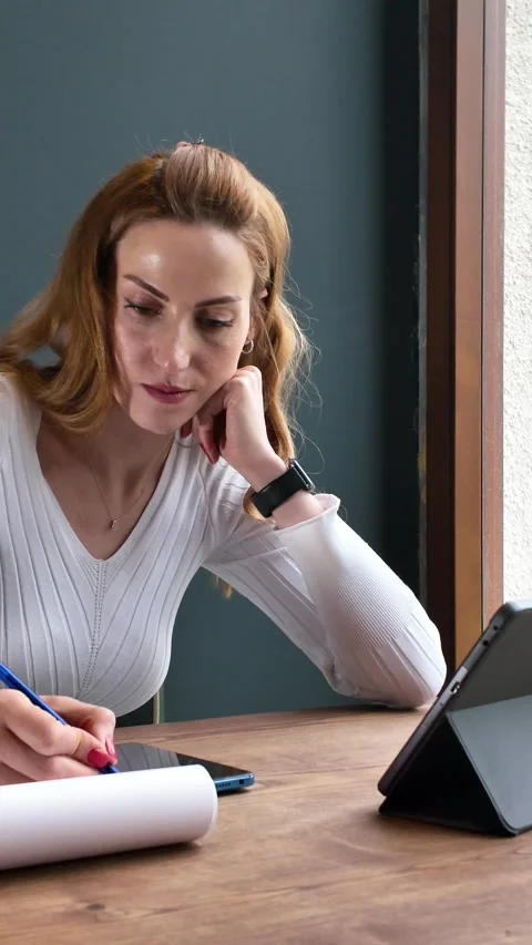 Close-up of thoughtful woman using tablet and planning work tasks Stock Footage 332619926