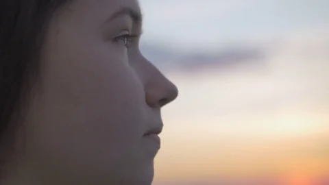 Close-up of thoughtful young girl looking up at the sky with hope. Stock Footage