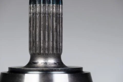 Close-up thread and spline joint of the shaft of the CV joint on a gray Stock Photos