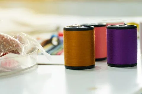 Close up The thread tube on the white table. Stock Photos