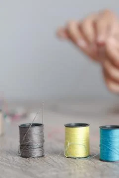 Close up the thread that was placed on the table to sew Stock Photos