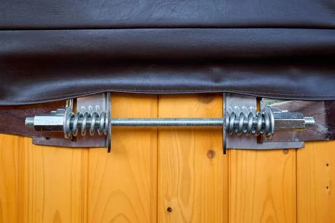 Close-up of threaded tension bolt with heavy-duty springs on steel structural Фото