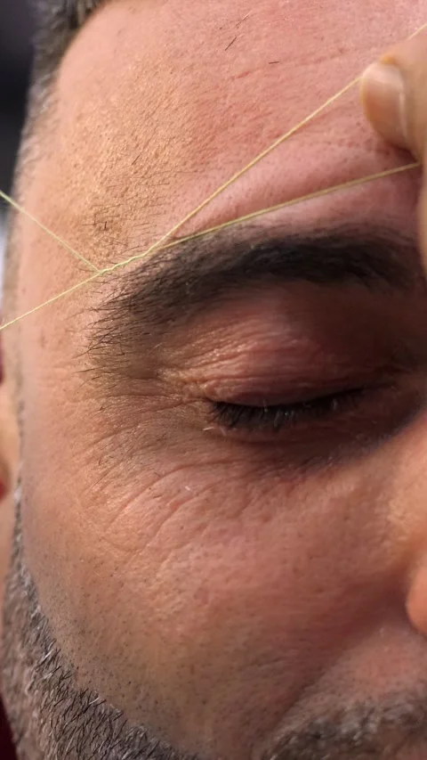 Close up threading eyebrows on young man detailed barber work Stock Footage 333199928