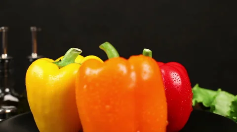 CLOSE UP: Three bell peppers turn in center of frame Stock Footage 39948485