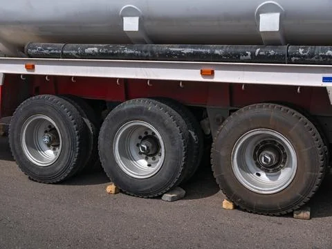 Close-up of three big black wheels on a truck trailer. Stock Photos