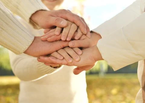 Close up of three Caucasian person stack their palms. Father, mother and son  Stock Photos
