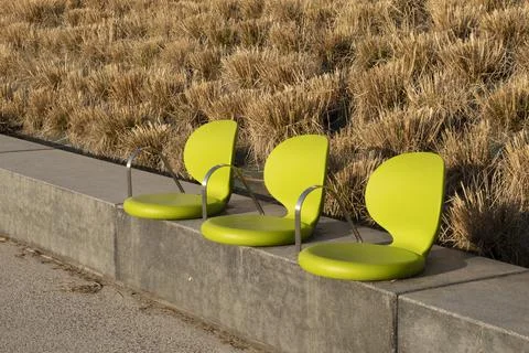 Close-up of three chairs on the walkway in the street Stock Photos