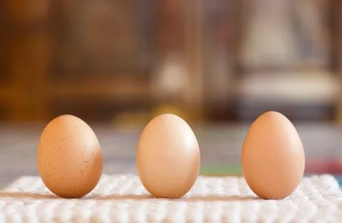 Close up of three chichen eggs on the table Stock Photos