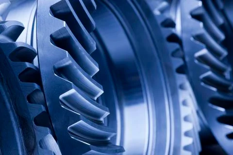 Close-up of three cog wheels in a row - focus on the foreground Stock Photos