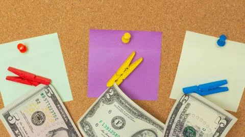 Close-up three colorful notes with pushpins and clothespins with dollars isol Stock Photos