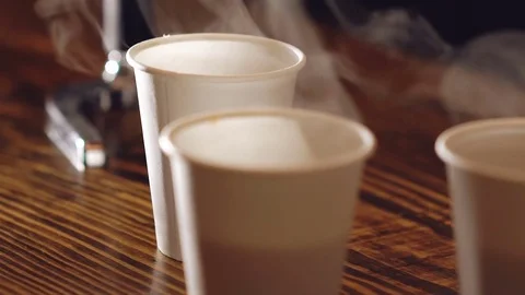 Close up of three cups of delicious coffee on the wooden table Stock-Footage 70266787
