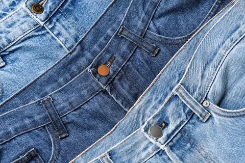 Close up of three different shades of blue denim jeans fabric texture with bu 库存照片