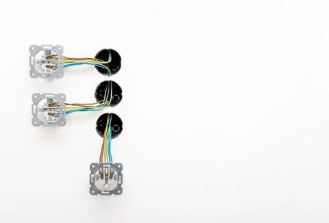 Close-up three electrical sockets on white wall. Stock Photos