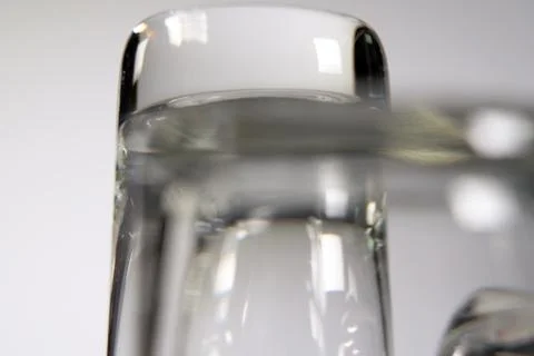 Close up of three empty shot glasses on white background. Stock Photos