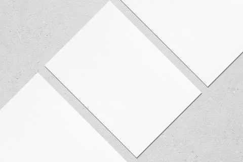 Close up of three empty white rectangle poster mockups lying diagonally on gr Stock Photos