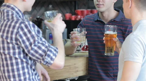 Close up of three friends drinking beverages at the bar Stock Footage 62709556