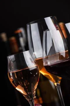 Close-up three glasses of red, white and sparkling rose wine with bunch of .. Stock Photos