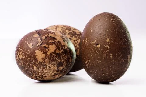 Close-up of three grungy colored Easter eggs on white Stock-Fotos