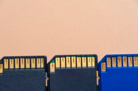 Close-up three memory cards lie on a beige table Stock Photos