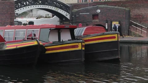 Close Up of Three Narrow Boat Barges Lined in a Row By Bridge Stock-Footage 44524799