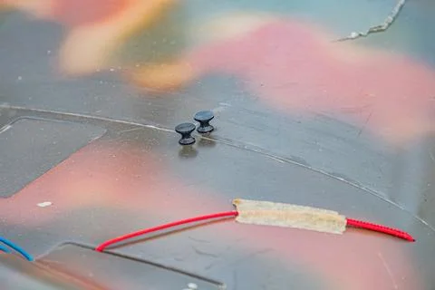 Close-up of three objects in an industrial setting two round discs with dark  Stock Photos