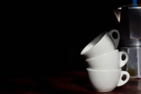 Close-up of three old white espresso cups stacked on top of each other in ... Stock Photos