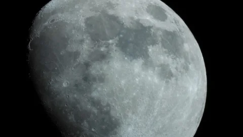 A close-up of a three-quarter moon in the night sky Video stock 106425340