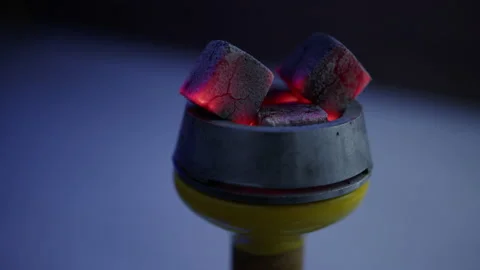 Close-up of three red-hot hookah coals on a light background Stock Footage 204842969