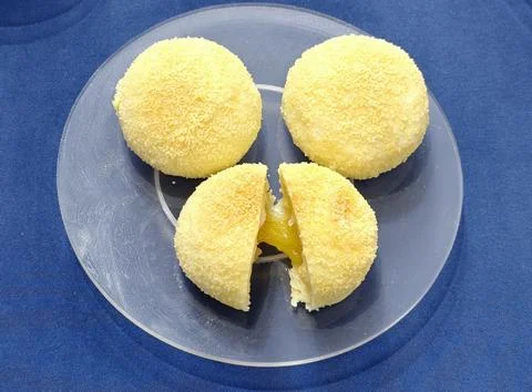 Close‑up of three round mango mochi desserts 写真素材