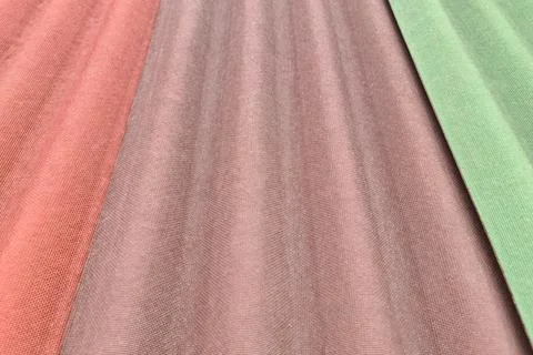 Close up on three sheets of ondulin of different colors. Modern cheap roofing Stock Photos