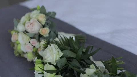 A close-up of three wedding bouquets made of beautiful white roses lying on a Stock Footage 322020413